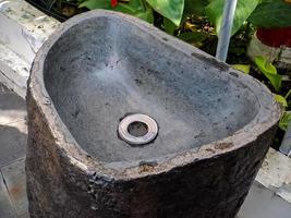 sink made of stone in a public park, for washing hands when covid hit the city area photo