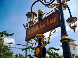 classic model city lights with black gold iron carvings, beautiful bright blue sky shot at low angle. photo