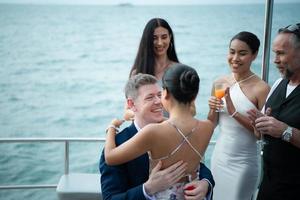 The appropriate time for a white man to propose to marry an Asian woman. on a yacht floating in the lovely water. photo
