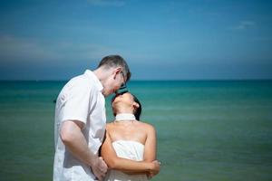 Interracial couple with the joy of traveling to the beautiful blue sea like the paradise photo