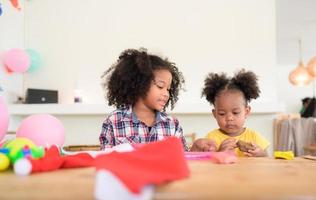 Two little girls Playing with plasticine photo