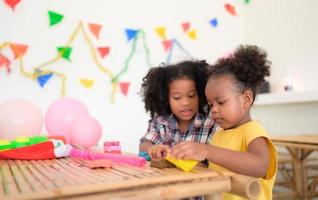 Two little girls Playing with plasticine photo