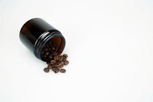 Arabica Coffee Bean in Brown Glass Jar on White Studio Background with Copy Space for Text. photo