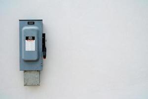 Heavy Duty Safety Switch Interruptor on Concrete Wall Background with Space for Text. photo