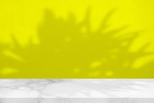 White Marble Table with Tree Shadow on Yellow Concrete Wall Texture Background, Suitable for Product Presentation Backdrop, Display, and Mock up. photo