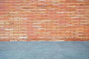 Red Brick Wall Background with Sand Pavement. photo