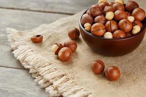 Macadamia nut on wooden background with vintage cloth, concept of superfoods and healthy food photo