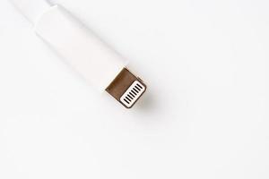 Connector lightning on a white background. This is a proprietary connector used to connect mobile devices to well-known host computers photo