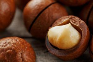 Macadamia nut on a wooden table in a bag, closeup, top view photo