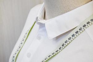 Close up mannequin with white shirt and waist measuring tape photo