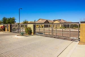 Two Electric Entry And Exit Gates With Brick Driveway photo