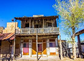Retro Two Story Western Buildings With Hanging American Flags photo