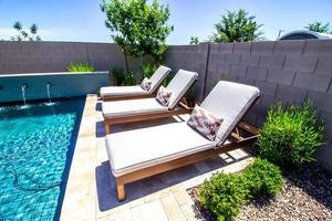 Rear Yard With Three Lounge Chairs And Swimming Pool photo