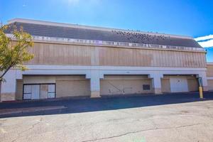 Abandoned Big Box Commercial Store With Boarded Up Entrance photo
