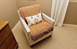 White Arm Chair With Decorative Pillow photo