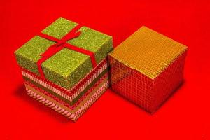 Two Christmas Gift Boxes On Red Background photo