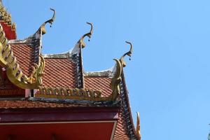 Gold gable apex the ornamental roof point with blue sky at Thailand temple photo