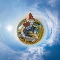 little planet and spherical aerial 360 panorama view on street ancient medieval castle with church and historic buildings with columns photo