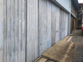 Photo of workshop door closed with corrugated iron.