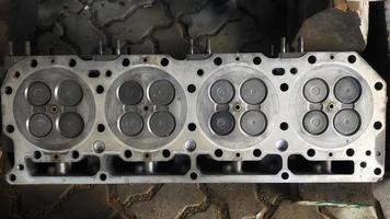 The engine cylinder head is sit above the cylinder chamber and regulates the mechanical rhythm of the combustion chamber. photo