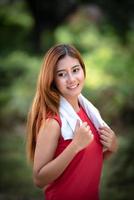 Portrait of Young Asian healthy sport woman enjoying and relaxing in the park. photo