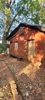 old clay house made of thatch photo