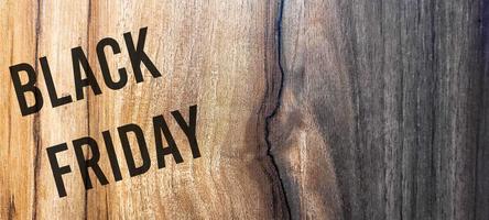 Black friday rustic wooden background, big black letters, sales promotion photo