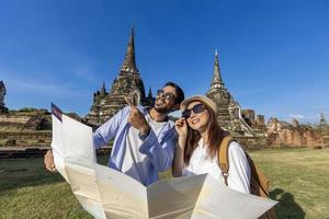 Couple of tourist come to visit at Wat Phra Si Sanphet temple, Ayutthaya Thailand using maps for travel, vacation, holiday, honeymoon and tourism concept