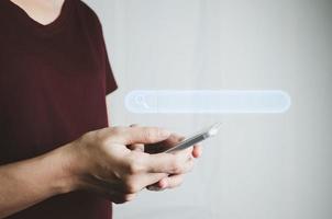 Search Engine optimization SEO concept, Businesswoman is using smartphone to search for information on Internet, Using the search bar, Wireless Network, big data and accessing website information. photo