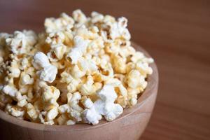 Popcorn in a wooden cup. Snacks. photo