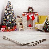 Empty white napkin on white wooden desk top view. Festive sparkling Christmas interiors background photo