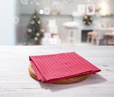 Empty pizza board and red napkin on white wooden and Christmas background photo