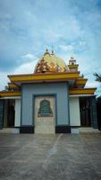 A beautiful mosque minaret building with a blend of yellow gold and orange photo