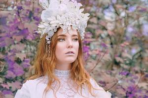 portrait of redhead beautiful young girl snow princess in a crown photo