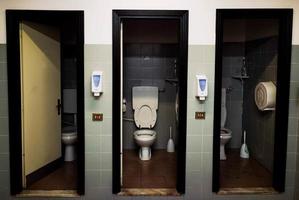 series of three toilets placed in the company made available to employees photo