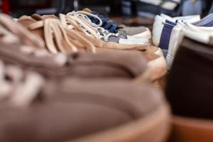 diversos zapatos de pie en los estantes de las boutiques. venta de temporada. compras. foto