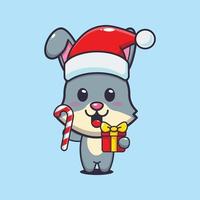 Cute rabbit holding christmas candy and gift. Cute christmas cartoon illustration. vector