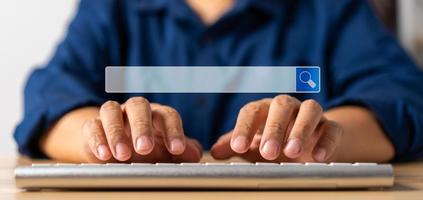 Businessman using a keyboard and notebook for searching information on the internet, searching browsing internet bar, Concept of Searching Browsing Internet Data Information Networking photo