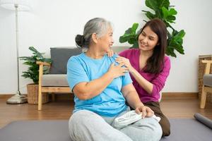 Asian careful caregiver or nurse taking care of the patient in a home.  Concept of happy retirement with care from a caregiver and Savings and senior health insurance, a Happy Family photo