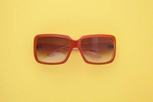 Summer background. Sunglasses isolated on colorful background. Top view and copy space. photo