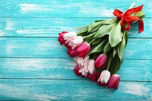Bouquet of tulips on turquoise rustic wooden background. Spring flowers bouquet. Spring background. Valentine's Day and Mother's Day background.