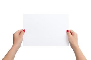 Girl's hands hold a blank paper in a horizontal position. Isolated background in white. Clean paper for copy presentation photo