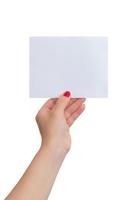 Woman's hand holds a small blank sheet of paper. Isolated background. Paper mockup for text presentation photo