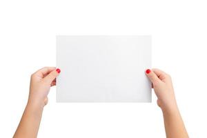 Girl's hands hold a blank paper in a horizontal position. Isolated background in white. Clean paper for copy presentation photo