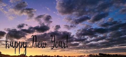 sky with clouds and a happy new year photo