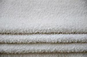 Close-up macro photo of a stack of many small white towels