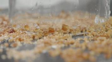 Shot of hand pouring whiskey into a glass with ice close-up. Alcoholic drink concept. selective focus. video