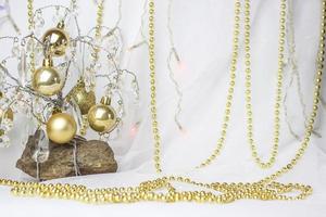 Christmas background with a Christmas tree on which small golden balls hang. Selective focus, a picture for the background. the concept of Christmas and New Year. photo