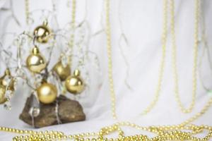 Christmas background with a Christmas tree on which small golden balls hang. Selective focus, a picture for the background. the concept of Christmas and New Year. photo