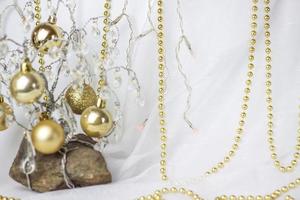 Christmas background with a Christmas tree on which small golden balls hang. Selective focus, a picture for the background. the concept of Christmas and New Year. photo